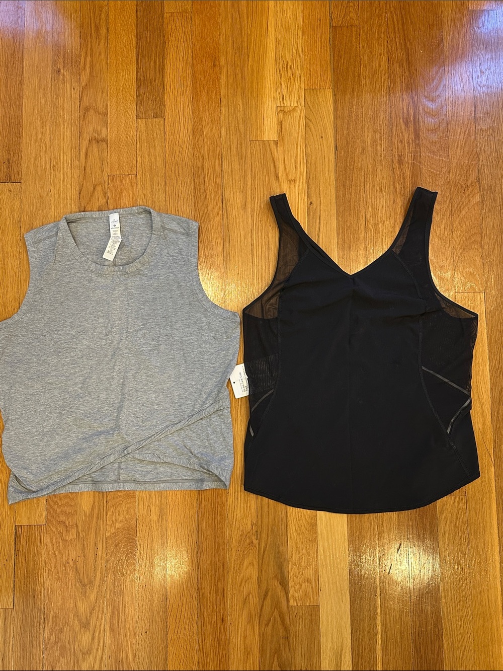 2 Lululemon Tanks- 1 black Run w/ sun (EUC), 1 gray do the twist (NWT), size 10